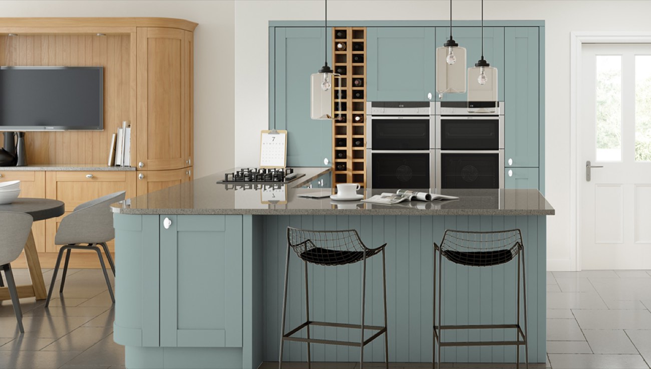 A Cambridge shaker kitchen in fjord blue, with a breakfast bar and pendant lighting