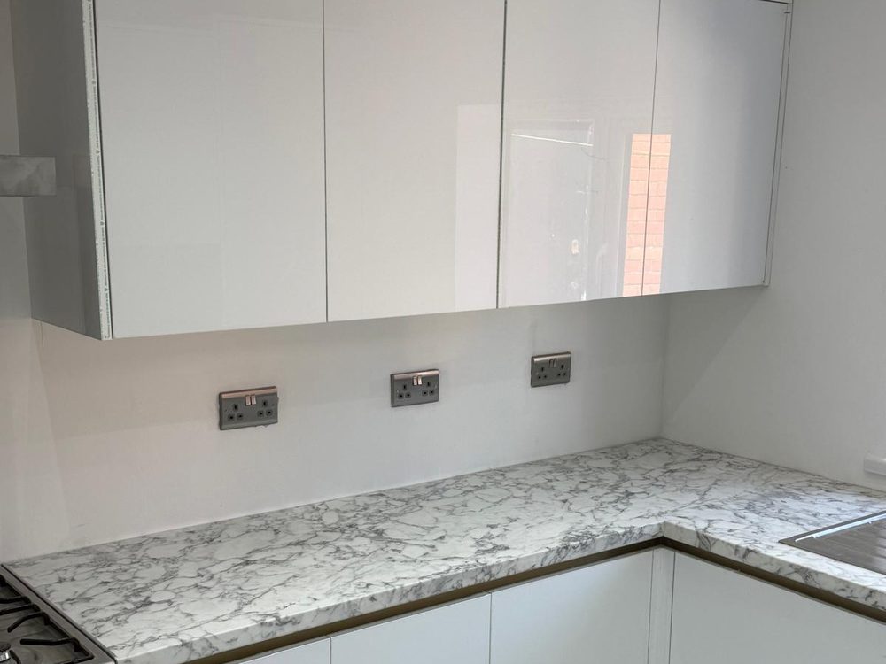 White gloss kitchen with marble-effect worktop